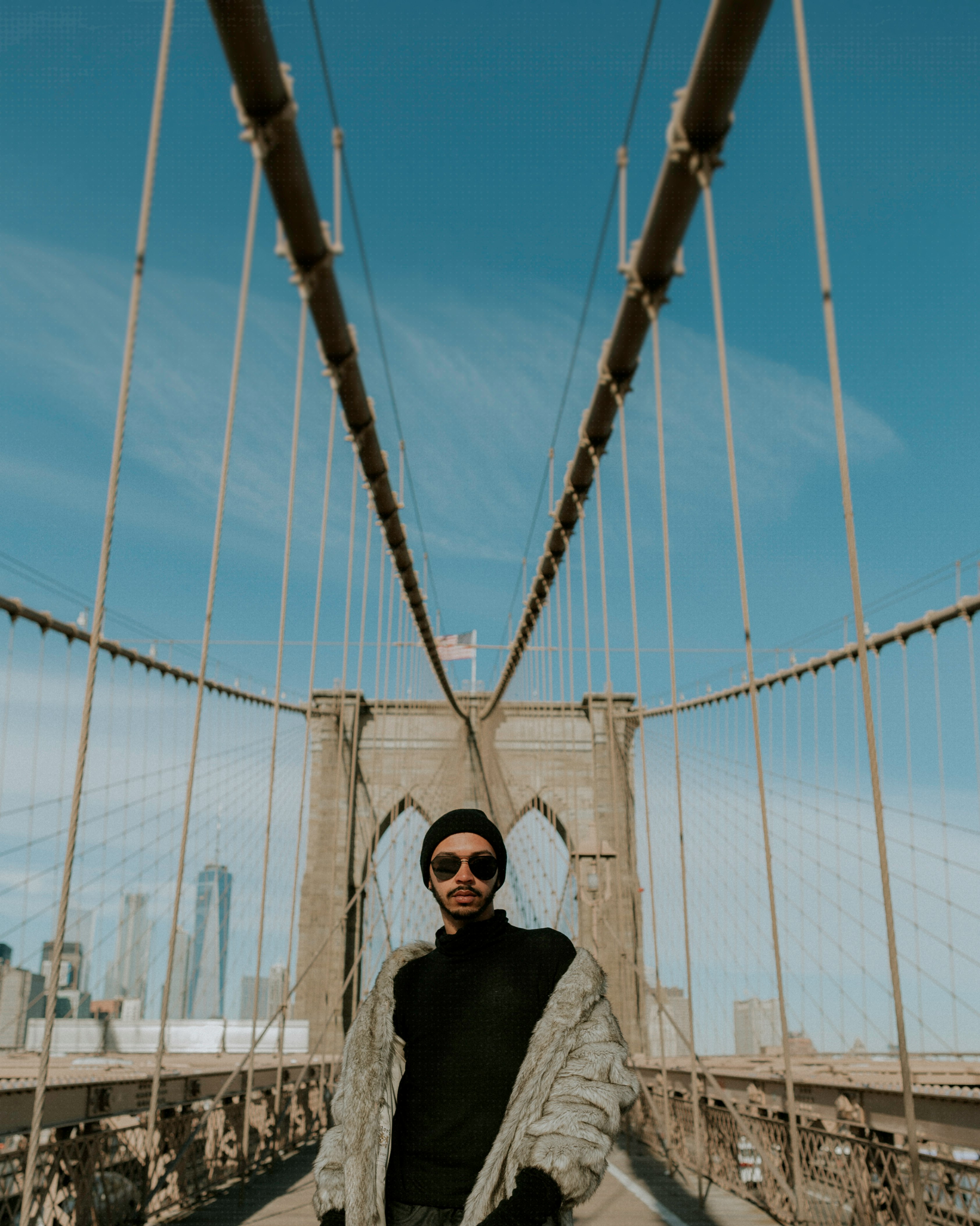 man standing between bridge during daytime